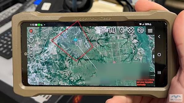 ATAK running on a rugged handset showing a mapped area with waypoints, a boundary and node markers